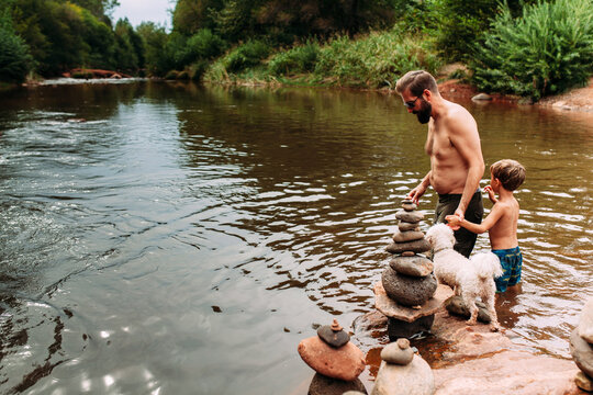 Father and Son and Dog Crossing a River
