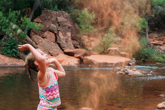 Child Throwing Sand 