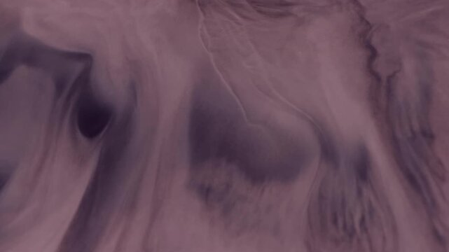 Spreading stains. Liquid marble. Defocused purple color paint texture in water chemical ink flow on abstract art acrylic background.