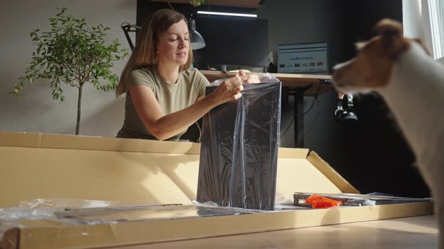 Woman unpacking shelving parts for furniture assembly at home