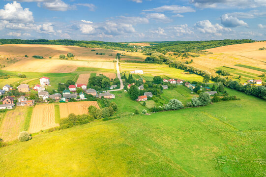 View from above of countryside. View of the village, cultivated fields, and farmland on the hills in summer