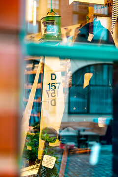 Reflections in a shop window with a sail and clothes in downtown Hamburg.
