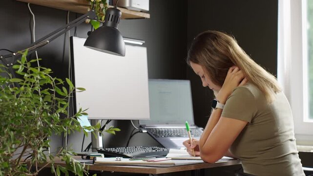 Woman working from home at desk in modern home office