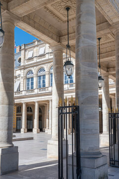 Columns and inner courtyard of the Palais Royal in Paris, France, on a sunny summer day