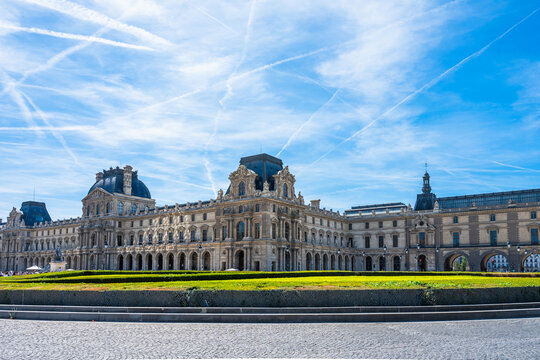 Visitors explore the Louvre museum in Paris, France during the summer months