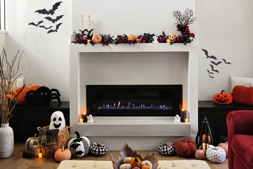 Fotobehang Sportwinkel Cozy Halloween decor display in a beautiful warm modern living room with burning fireplace and candles  © Jenifoto