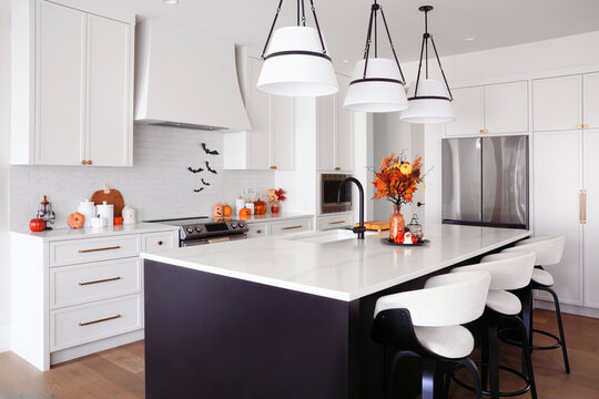 Beautiful modern black and white kitchen with Halloween cookware and decor display