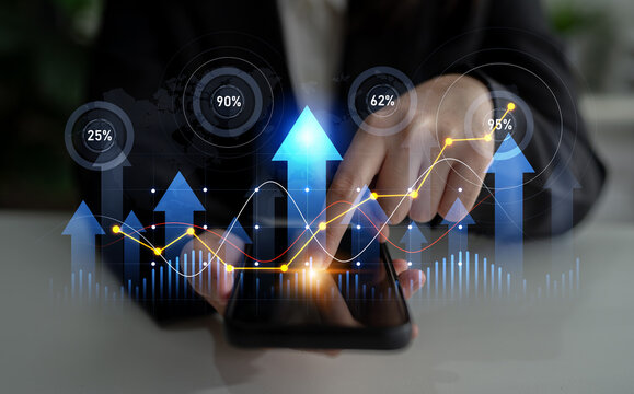 A professional woman interacts with a smartphone featuring animated growth charts and data visualizations, symbolizing business analytics and market progress. Scalp