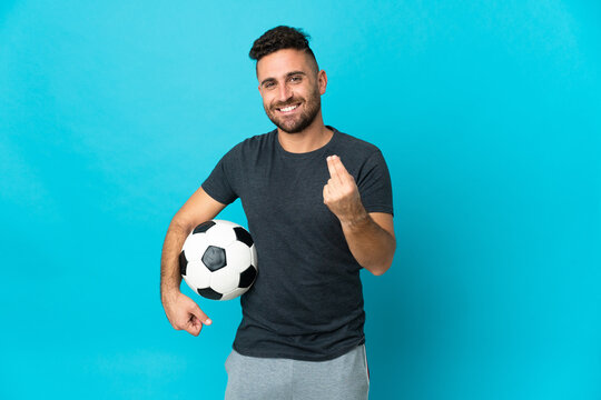 Football player isolated on blue background making money gesture