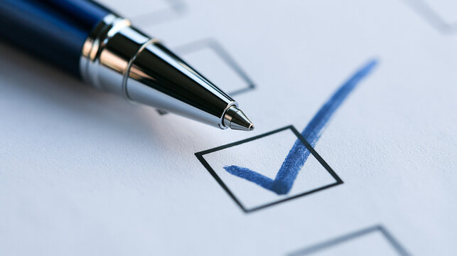 A close up view of a ballpoint pen marking a blue checkmark in a checkbox on white paper. Perfect for business success and survey concepts.