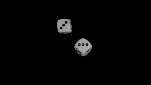 Dice rolling in slow motion shows detailed movement and dynamics of falling objects