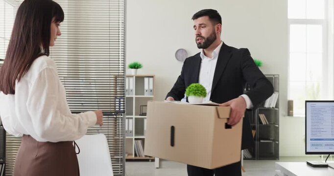 Employee and manager in office during dismissal. The worker carries a cardboard box as the boss points to the exit, showing termination or layoff and conflict. Clear concept of job loss.