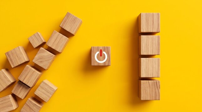 Minimalist wooden blocks with power icon on yellow background, conceptual business startup and activation metaphor, creative leadership and energy