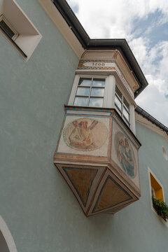 Ortisei, Urtij&euml;i, St. Ulrich, Italy. Historic painted oriel with Saint Andrew frescoes and decorative Alpine facade in Val Gardena