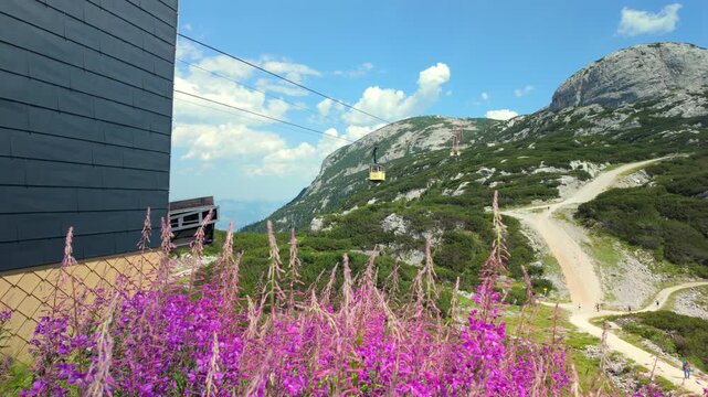 Dachstein Krippenstein, iconic bright yellow cable car cabins and gondolas that transport visitors up the mountain slopes in Obertraun, Austria.