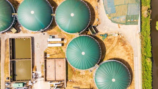 Aerial drone view looking straight down at some anaerobic digester tanks at a water treatment facility.  Creating renewable energy from biomass