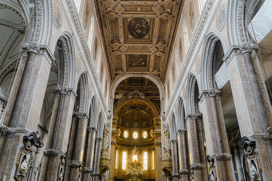 Grand interior of historic cathedral with ornate columns and vaulted ceiling.