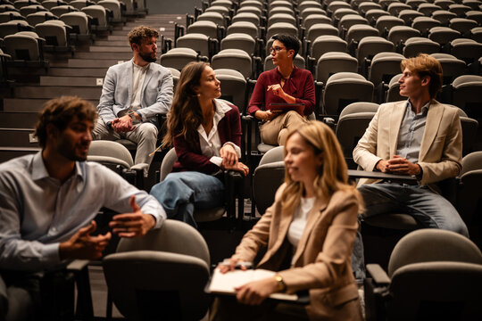 Business professionals attending a seminar in an auditorium