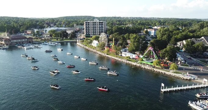Aerial drone video of the lake water and carnival rides in Lake Geneva, Wisconsin.