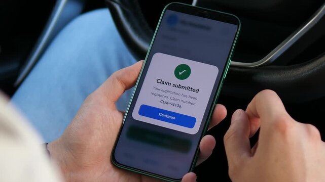 Driver confirms a digital insurance claim on a smartphone, reflecting the rise of mobile insurtech, paperless claims and faster online customer service.