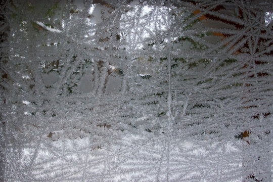 looking out abstract ice crystal covered window