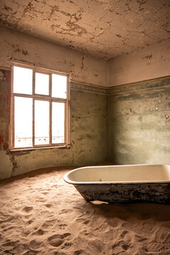 vertical Sand filling an abandoned bathroom in Kolmanskop ghost town