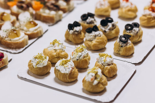 Gourmet Appetizers Platter: A delectable assortment of bite-sized appetizers, featuring delicate pastries, canap&eacute;s, and savory treats, arranged artfully on platters.
