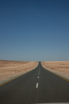 vertical Endless road disappearing into the horizon in Namibia desert