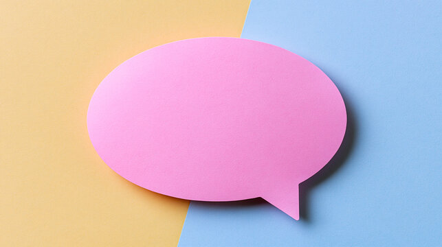 A pink speech bubble cutout rests on a colorful yellow and blue background. Creative communication concept for social media marketing and messaging campaigns.