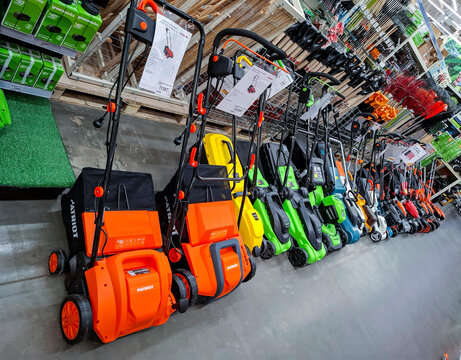 Voronezh, Russia - April 19, 2026.Colorful lineup of walk behind lawn mowers and scarifiers in showroom