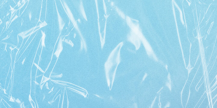 Transparent plastic wrap texture on blue background, wrinkled cellophane overlay, realistic polyethylene film for packaging design