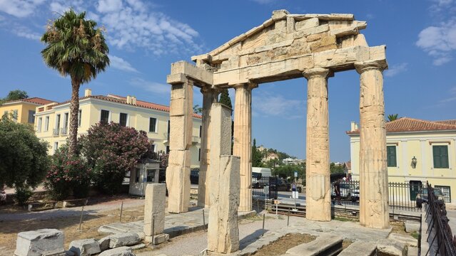 Roman Agora, Athens, Greece - 8 July 2026. Gate of Athena Archegetis with four Doric columns and its surviving marble pediment beside modern Athens.