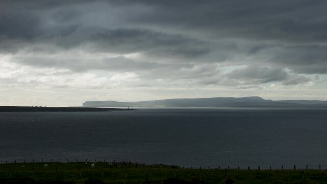 Outline of the Orkney Islands visible on the horizon from Dunnet Head in northern Scotland
