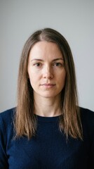 Obraz premium Portrait of a woman with fine thin brown hair. Female with straight low volume hair looking at camera. Hair care and texture concept
