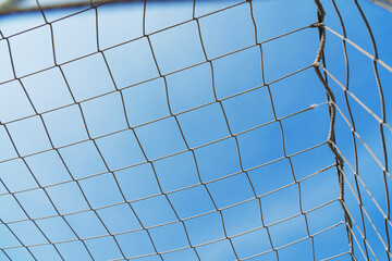 Fototapeta premium Close-up textured soccer net on soccer goal isolated on free sky background.