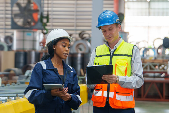 Team Collaboration in Manufacturing: Professionals Discussing Safety Compliance for Training and Marketing Resources