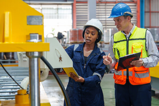 Workers Inspecting Industrial Equipment During Safety Training for Effective Team Collaboration in Manufacturing