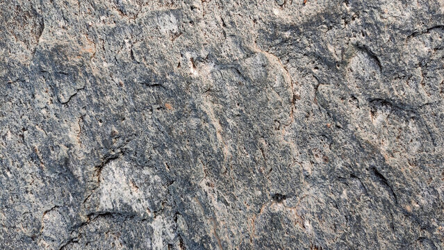 Rough foliated rock texture granite surface crystalline grains grainy background
