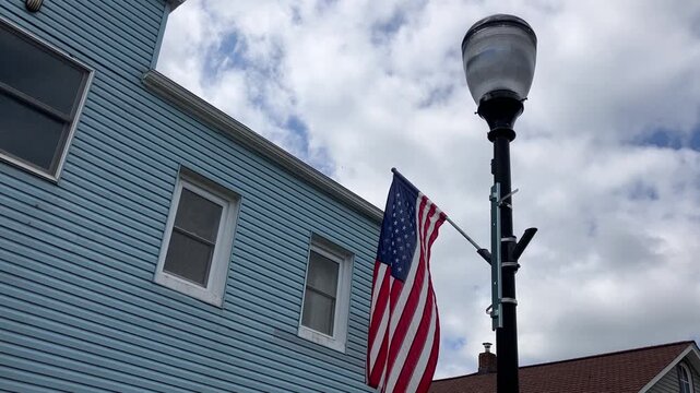 american flag on a street light pole