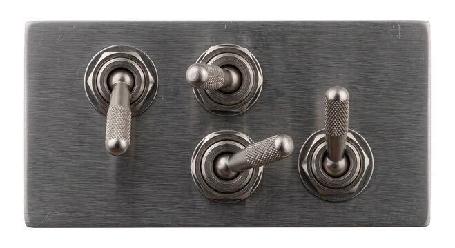 Set of four vintage metal toggle switches on a brushed aluminum panel