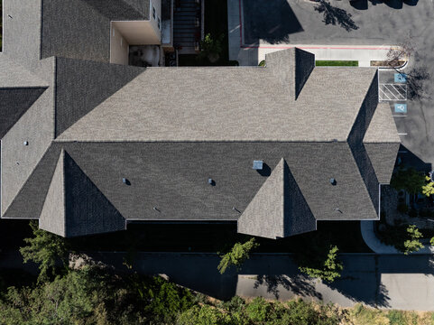 Top-down photo of residential house with angular roof design and landscaped yard