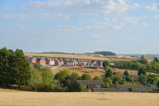 Houses in the distance across a field 