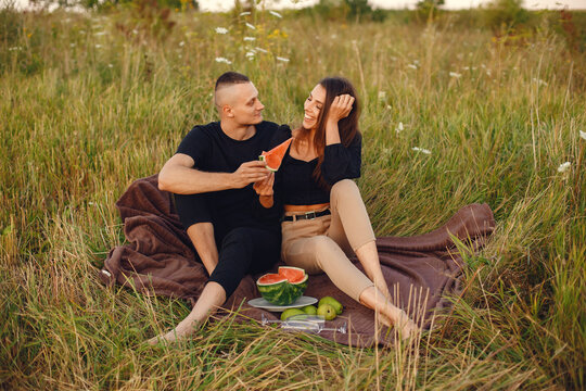 Beautiful couple spend time on a summer field