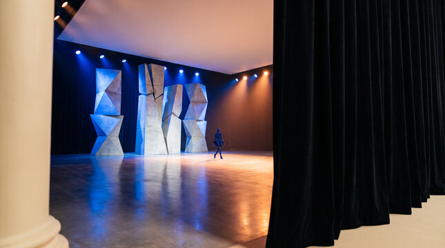 Empty runway stage design with dramatic lighting and set structures  