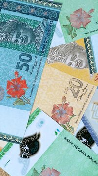 Malaysian ringgit money bills in pile on table. Malaysia MYR currency cash close up