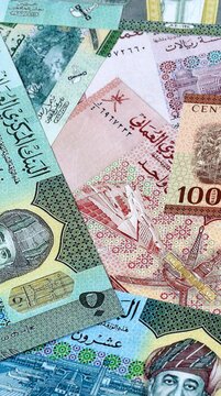 Omani rial money bills in pile on table. Oman OMR currency cash close up