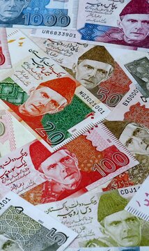 Pakistani rupee money bills in pile on table. Pakistan PKR currency cash close up