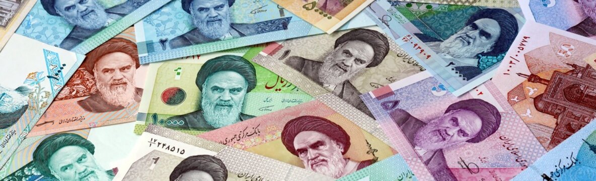 Iranian rial money bills in pile on table. Iran IRR currency cash close up. Concept of gambling