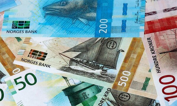Norwegian krone money bills in pile on table. Norway NOK currency cash close up