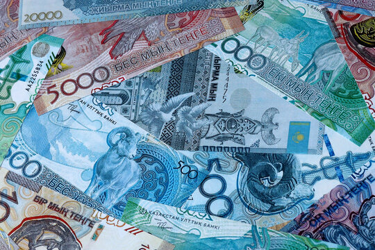 Kazakhstani tenge money bills in pile on table. Kazakhstan KZT currency cash close up
